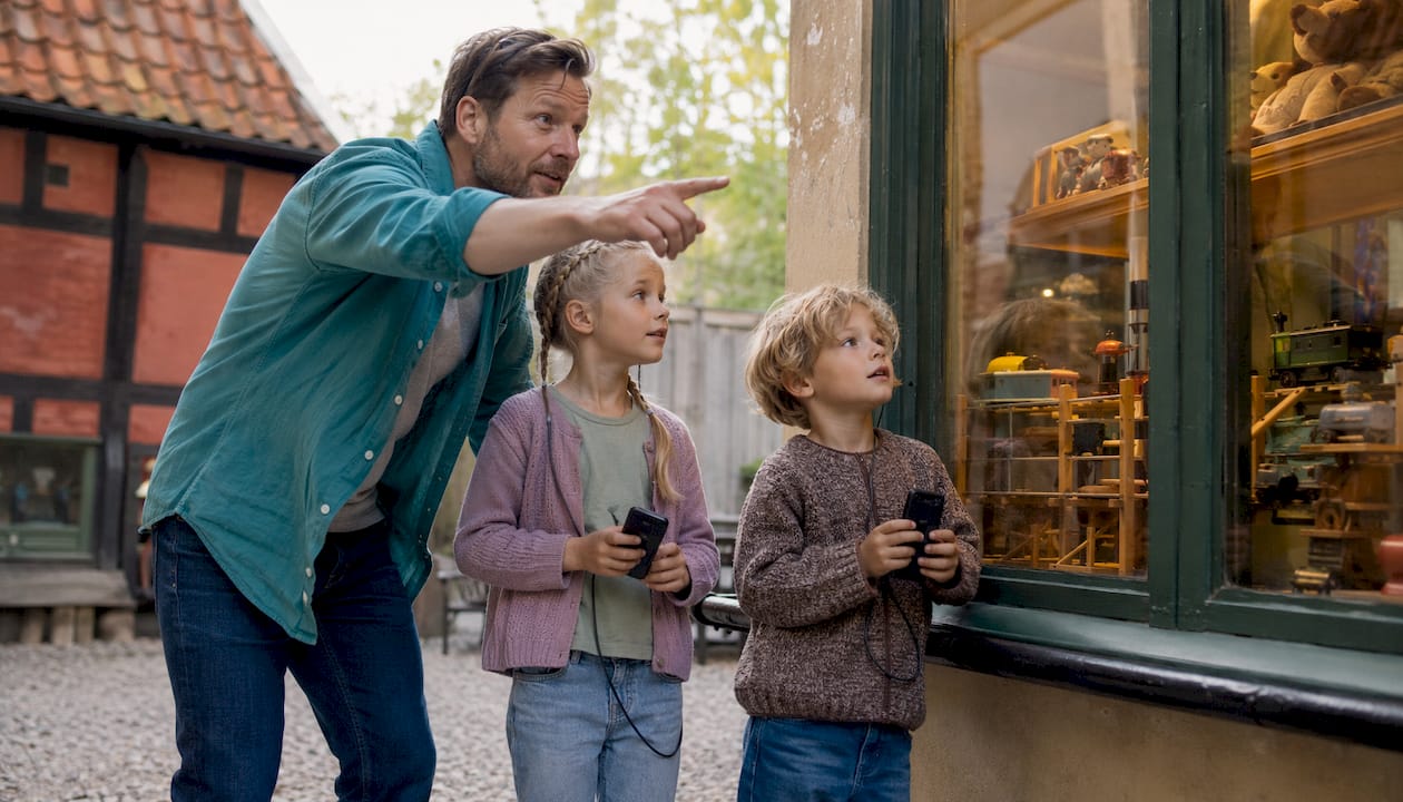 En familie er på opdagelse blandt de spændende udstillinger i Den Gamle By.